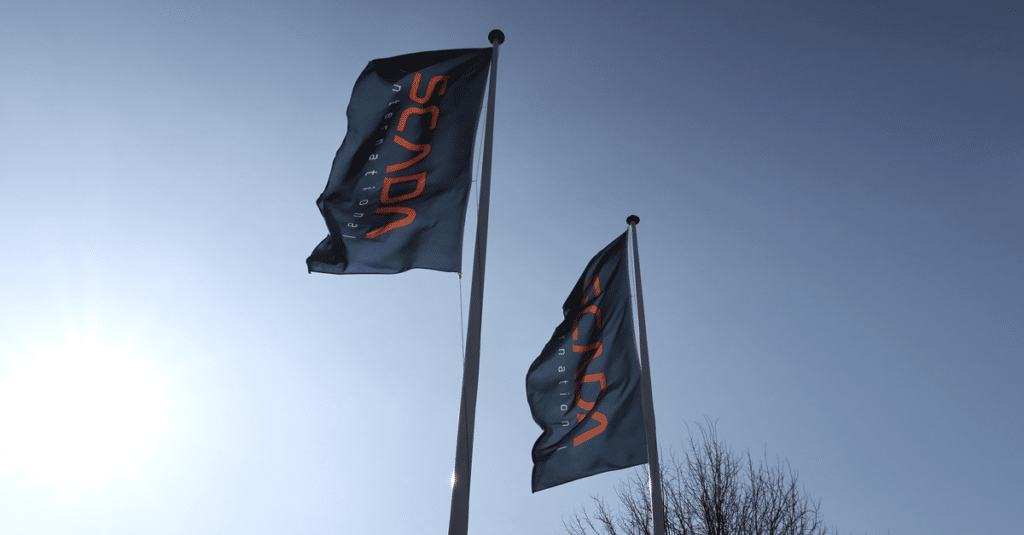 SCADA International flags waving in the wind with a blue sky